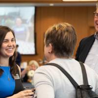 emily talking with attendees